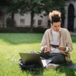 Deep Dive: Choosing Between Online, Hybrid, and On-Campus Study Programs, student comparing study options with laptop and campus view