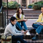 International Student Survival Guide: From Visa basics to campus enrollment steps shown on a university campus signboard