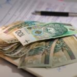 Student comparing Master’s vs. PhD: Key Differences, Costs, Funding, and Career Outcomes on a study desk.