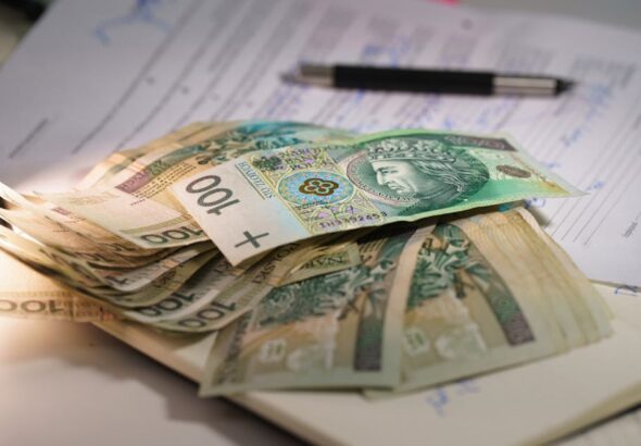 Student comparing Master’s vs. PhD: Key Differences, Costs, Funding, and Career Outcomes on a study desk.