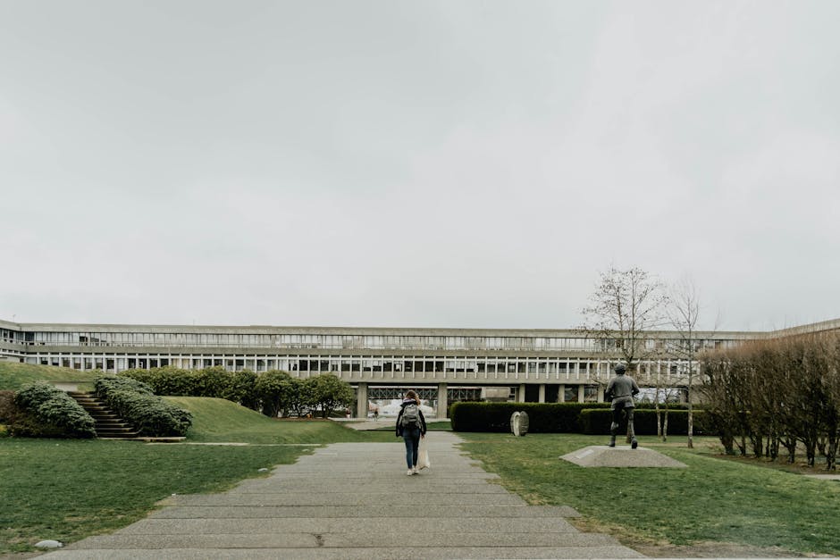 International student holding documents while checking in at a university office