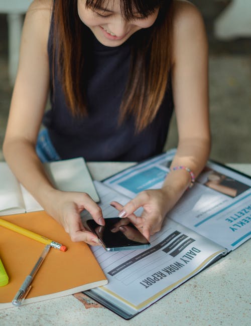 Student using a phone to score and compare schools after a virtual tour