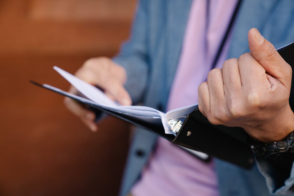 Student reviewing official transcripts and IDs at a desk before uploading