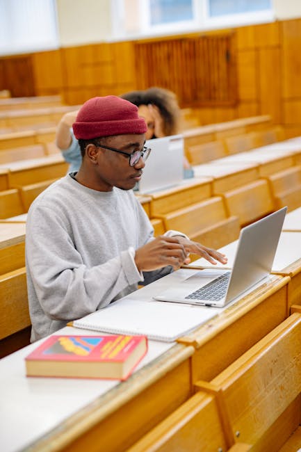 Student reviewing university application requirements on a laptop portal
