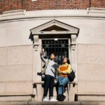 Student on campus asking Top 10 Questions to Ask During a University Campus Visit before you enroll, with tour guide.