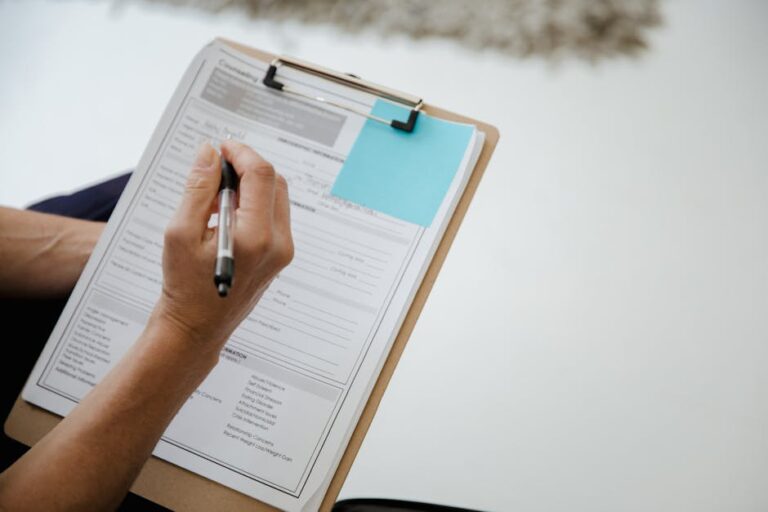 Admissions Checklist: How to Prepare a Strong Application in 30 days—student reviewing notes and laptop on desk.