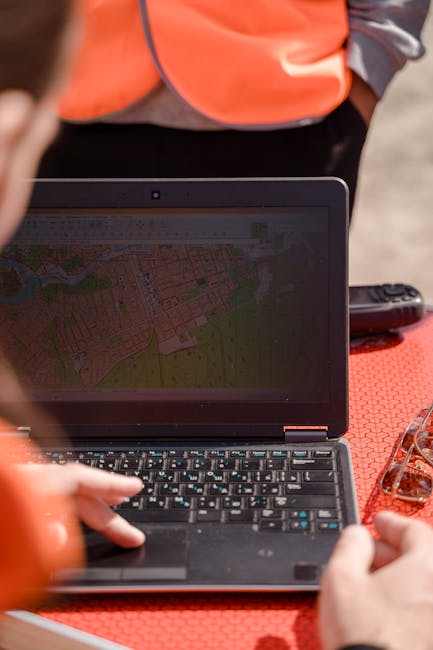Planner reviewing site sketch and measurements for upcoming earthmoving near campus