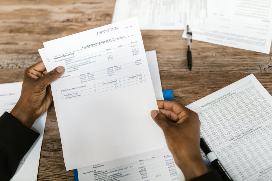Close-up of hands holding financial documents and paperwork for German visa application