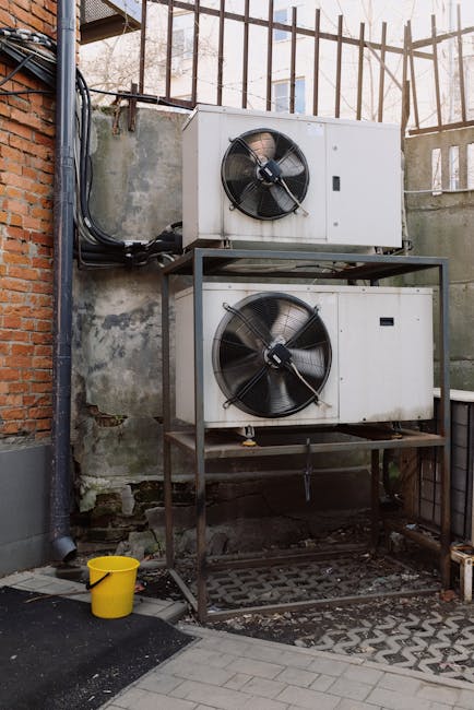 Close-up of an HVAC air vent with a technician checking airflow