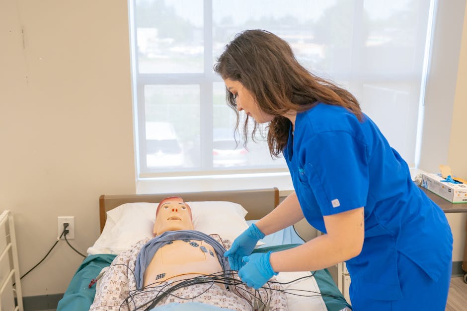 Student practicing in a nursing lab with instructors and lab equipment