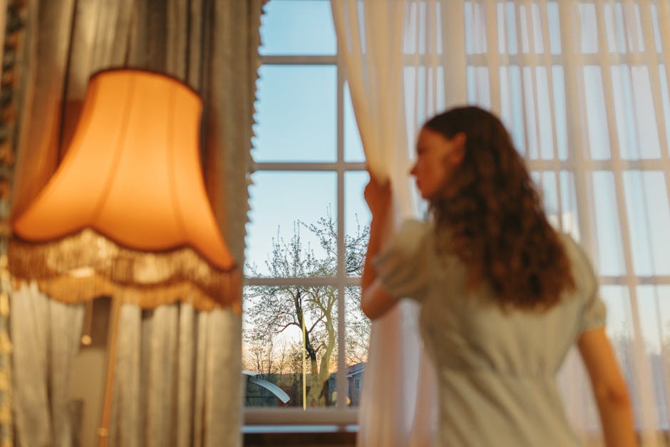 Student opening a window for fresh air in a modern apartment