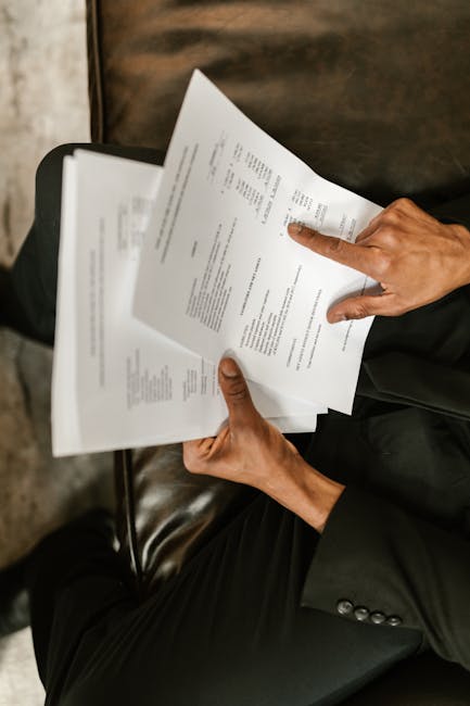 Admissions-style review with a person scanning paperwork and a checklist