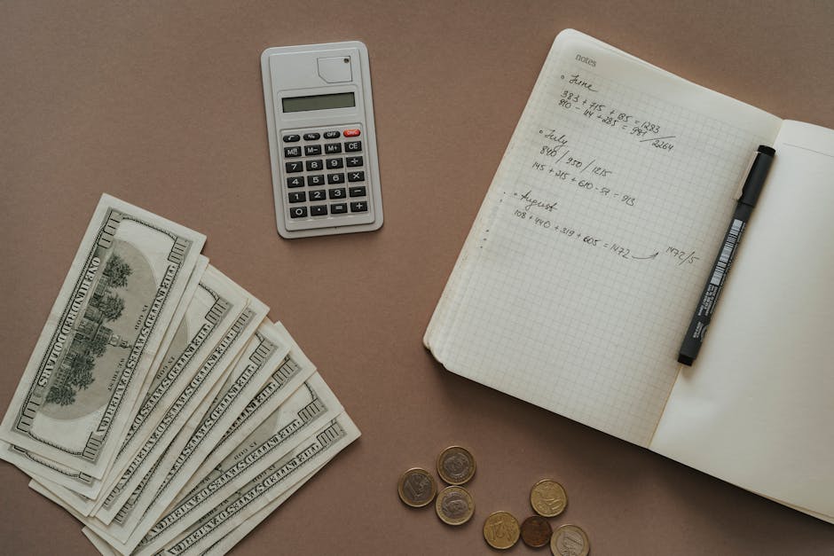 Student calculating a budget with notebook and laptop to compare total education costs