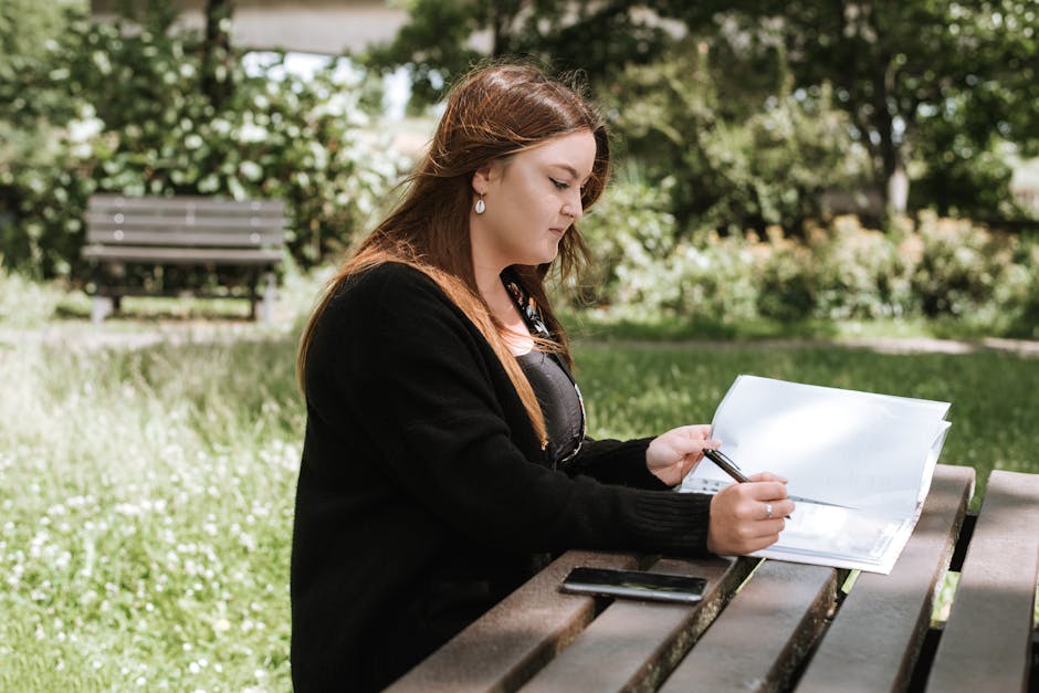 Student comparing college outcome reports, advising info, and program details at a desk
