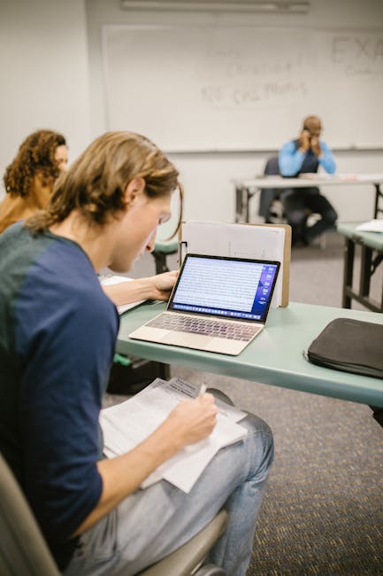 Student studying GRE and GMAT practice questions at a desk with notes