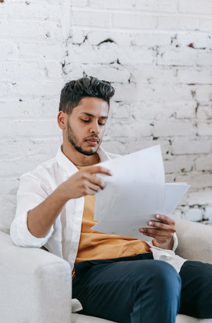 Person reviewing UK student visa documents and CAS details on a desk