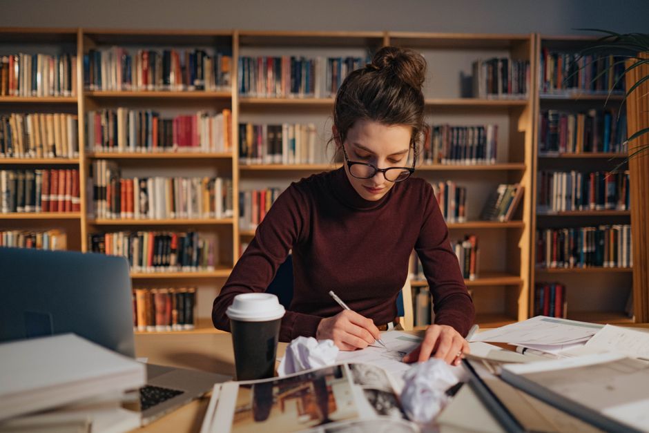 Student studying and preparing application materials in a focused workspace