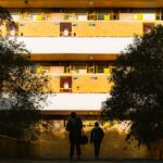 Students enjoying Campus Life Deep Dive in a shared dorm lounge during daily student living, bright morning light.