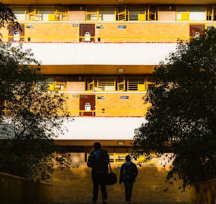 Students enjoying Campus Life Deep Dive in a shared dorm lounge during daily student living, bright morning light.