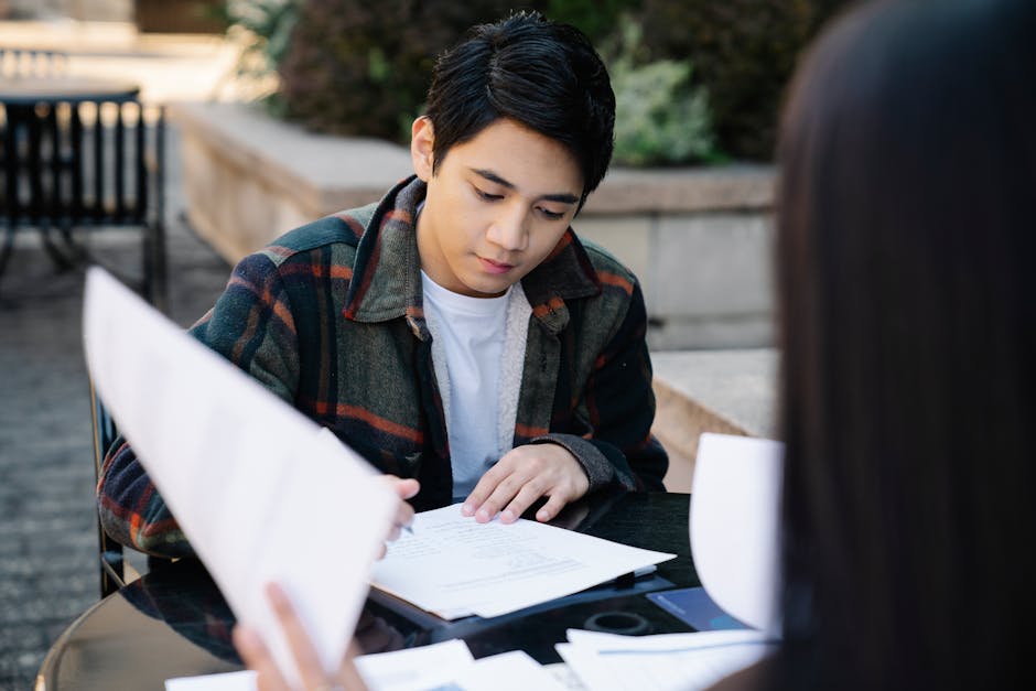 Student reviewing a financial aid letter and paperwork at a desk